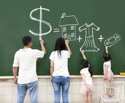 parents and children draw items they want to buy on chalkboard