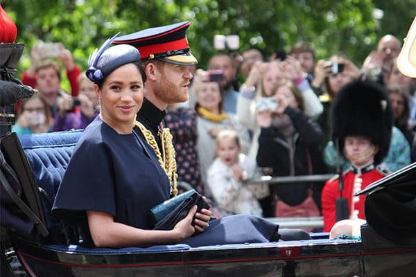 Meghan Markle and Prince Harry riding in a royal carriage