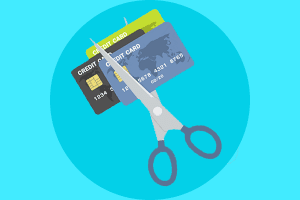 Scissors cutting up closed credit cards