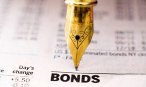 Photo of gold pen writing on bond indices paper