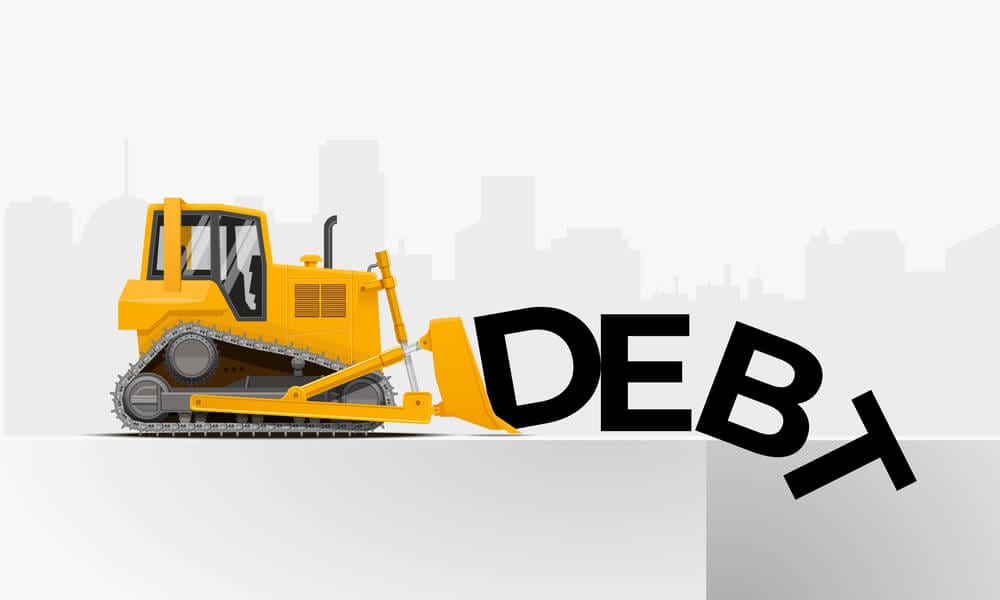 Yellow bulldozer pushing the word debt to the pit