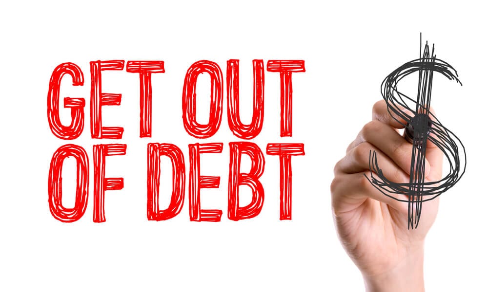 Hand with marker writing the word Get Out of Debt