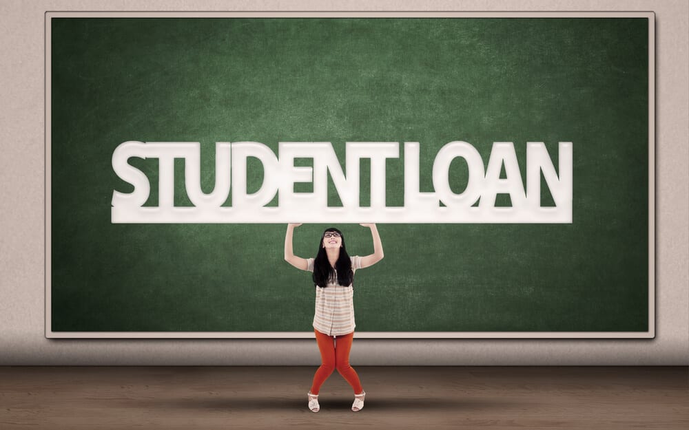 Student woman holding up the words student loan with both hands