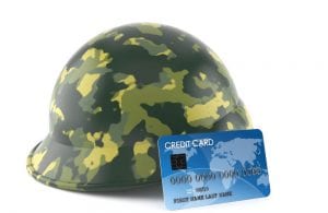 Military hard camo helmet with credit card leaning on it