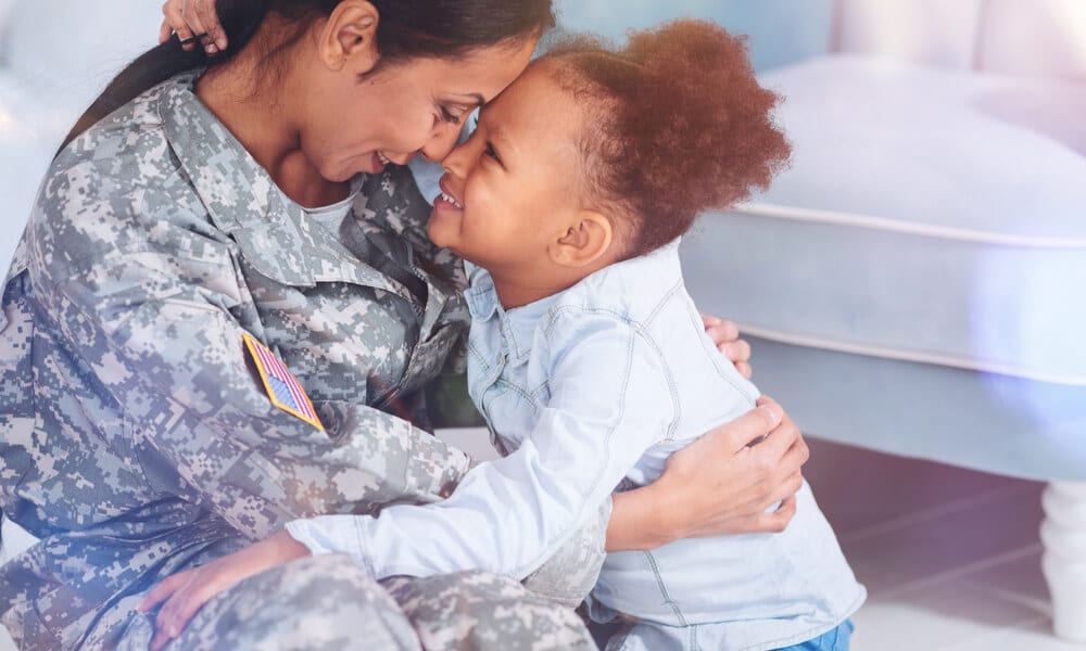 Happy military mother and daughter smiling and hugging