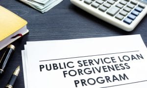 Document lying on table titled "Public Service Loan Forgiveness Program"