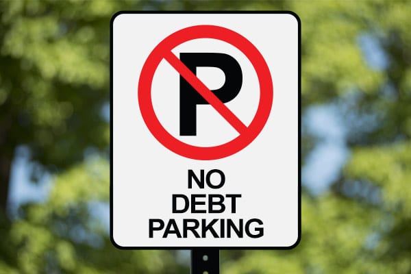 Parking sign that says "NO DEBT PARKING"