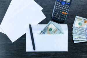 Money inside of envelope on a desk