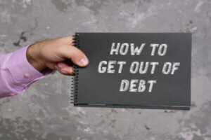 HOW TO GET OUT OF DEBT sign on the page.